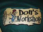 Wood engraving of a a sign for don's workshop